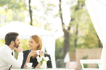 Smiling couple at outdoor cafe - WESTF020437