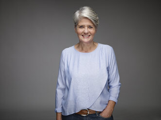 Portrait of mature woman with grey hair in front of grey background - RH000461