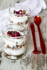 Two glasses of natural yoghurt with granola, chocolate shaving and pomegranate seeds - SARF001205