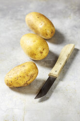 Unpeeled potatoes and knife - EVGF001079