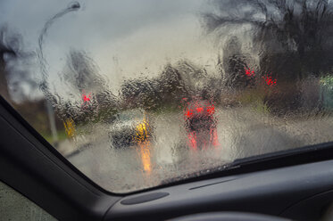 Germany, Grevenbroich, View through windscreen at crossroad at rainy wetter - FRF000161