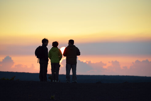 USA, Hawaii, Big Island, Volcanoes National Park, drei Personen beobachten den Sonnenuntergang am Kilauea Iki - BRF000917