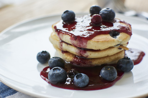 Lemon blueberry pancakes with blueberry syrup stock photo