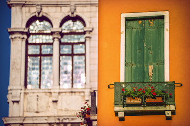 Italy, Venice, house facade with closed shutters and palazzo in the background - EHF000043