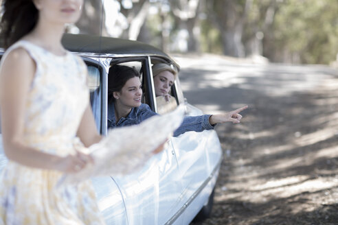 South Africa, Young woman on road trip with friends looking for directions - ZEF002779