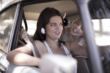 South Africa, Friends on road trip driving in car listening to music - ZEF002725