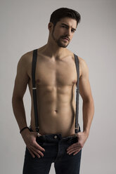 Shirtless man wearing jeans and suspenders - SHKF000121