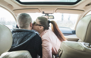 Woman kissing man in car - DEGF000107