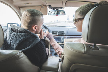 Couple traveling in car with man smoking a cigarette - DEGF000108