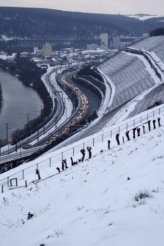 Deutschland, Würzburg, Weinberg und Verkehr am Main im Winter, lizenzfreies Stockfoto