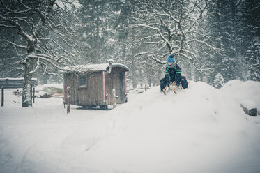 Germany, Bavaria, Berchtesgadener Land, boy on sledge - MJF001377