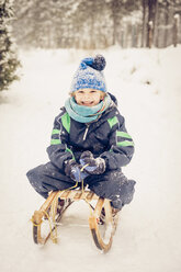 Germany, Bavaria, Berchtesgadener Land, happy boy on sledge - MJF001381