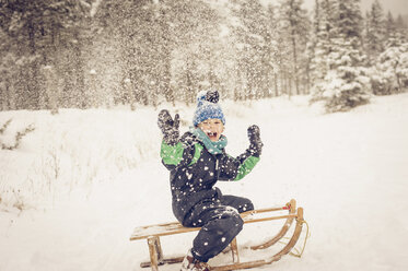 Germany, Bavaria, Berchtesgadener Land, happy boy on sledge - MJF001382