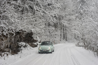 Germany, Bavaria, Berchtesgadener Land, car on rural road in winter landscape - MJF001393