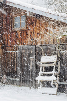 Deutschland, Bayern, Berchtesgadener Land, Schneefall am Holzhaus - MJ001428