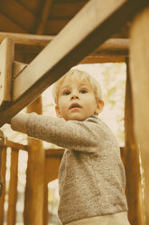 Portrait of toddler leaning at playground equipment - MFF001354
