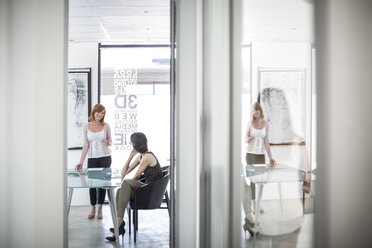 Businesswomen having a meeting in conference room - ZEF003094