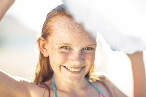 Porträt eines lächelnden Mädchens am Strand, lizenzfreies Stockfoto