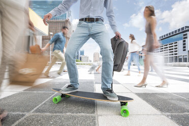 City commuter on a skateboard between a crowd of people - ZEF003966