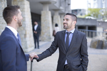 Gay couple with business suits facing each other - ZEF002890