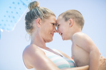 Happy mother and son on beach - ZEF003394