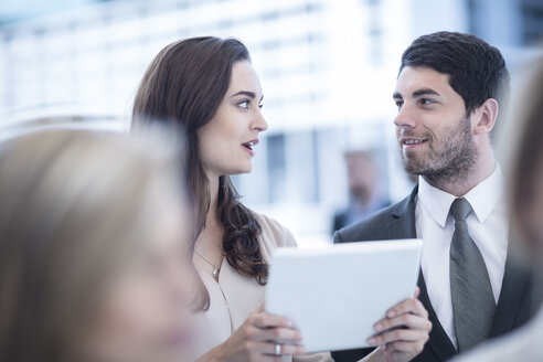 Businessman and woman with digital tablet in the city - ZEF003240