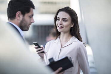 Businessman and woman with diary and cell phone in the city - ZEF003258