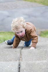 Little girl crawling up stairs - NNF000331