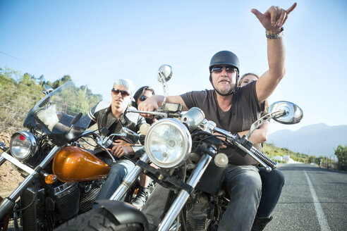 Friends riding motorcycles on open road - ZEF003577
