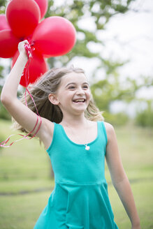 Portrait of smiling girl with red balloons - ZEF004392