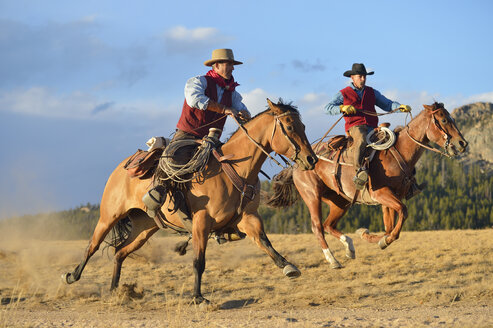 USA, Wyoming, zwei reitende Cowboys - RUEF001389