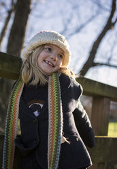 Portrait of smiling girl wearing and wool cap and scarf - MGOF000006