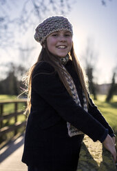 Portrait of smiling girl wearing wool cap and scarf - MGOF000009