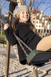 Portrait of smiling girl on a swing - MGOF000011