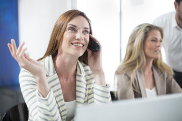 Businesswoman in office talking on telephone - ZEF003101