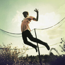 Boy jumping on trampoline - MSF004434