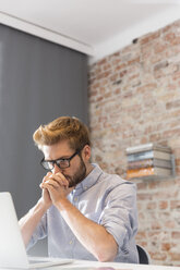 Young man at desk using laptop - WESTF020602