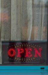 Neon sign behind windowpane of a pub - EJW000610