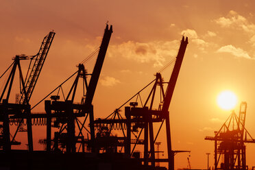 Germany, Hamburg, harbour, cranes at sunset - KRPF001273