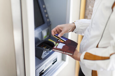 Woman at cash machine - NNF000193