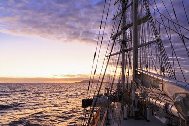 Pacific Ocean, sailing ship at Galapagos Islands at sunset - FOF007548