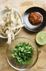 Mushrooms, spring onions, lime and sambal on bamboo plate - FLF000793