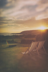 France, Brittany, Finistere, deckchairs at sunset by the sea - ON000769