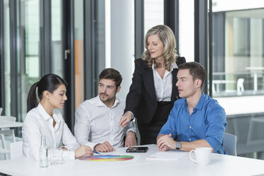 Meeting of four business people in a conference room - SHKF000156