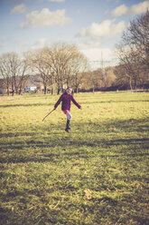 Little girl jumping on a meadow - SARF001235