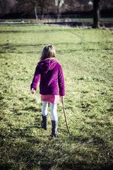 Little girl walking on a meadow - SARF001236