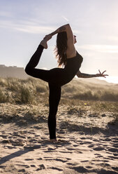 Spain, Asturias, Aviles, woman practicing yoga on the beach - MGOF000033