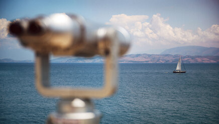 Greece, Ionic Islands, Corfu, Binoculars at the sea and a sailing boat - EHF000071