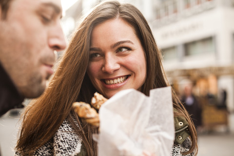 Germany, Cologne, young coupleeating pastry stock photo