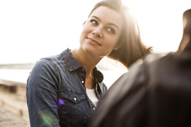 Portrait of smiling young woman playing with her hair - FEXF000273